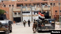 Iraqi security forces gather in center of Fallujah on June 20. 