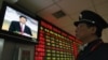 A security guard in Huaibei watches a screen showing newly appointed Communist Party General Secretary Xi Jinping speaking during a news conference.
