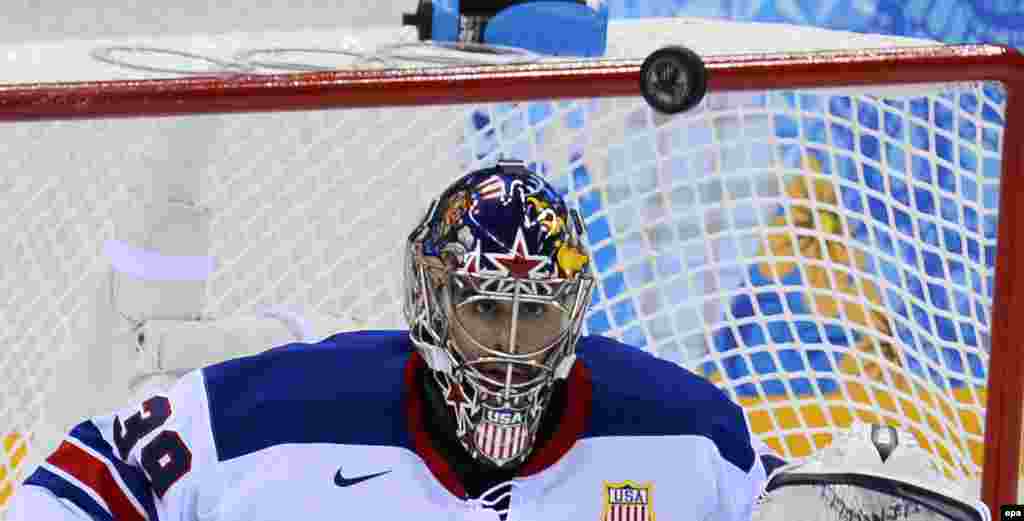 Goalie Ryan Miller of United States blocks the puck against Slovenia in the first period during their ice-hockey match. (epa/Larry W. Smith)