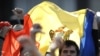 Protesters wave the Moldovan flag near the government building in Chisinau on April 8