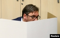 Vucic prepares his ballot at a polling station in Belgrade on April 2.