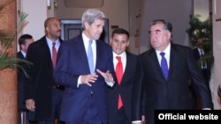 U.S. Secretary of State Jon Kerry (left) speaks with Tajik President Emomali Rahmon in Dushanbe on November 3.