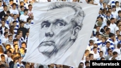   Fans hang a banner with the portrait of Valerii Lobanovsky 