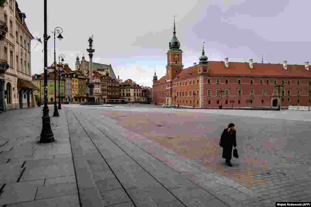 Poland - A woman walks on an empty square in the center of Warsaw, 14Mar2020