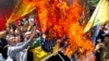 State organized demonstrators burn Israeli and U.S. flags to show their anger over the deaths of nearly 60 Palestinians along the Gaza border on Monday, during a protest outside the former U.S. embassy in Tehran, May 16, 2018. File photo