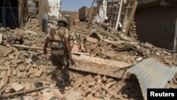 A Pakistani soldier walks at a house which was destroyed during a military operation in North Waziristan. (file photo)