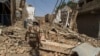 FILE: A Pakistani soldier walks in a house destroyed during a military operation in the of town of Miran Shah, North Waziristan in July 2014.