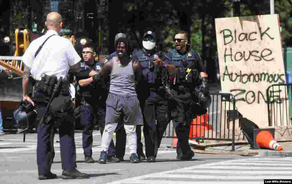 Washington, D.C. Metropolitan Police officers detain a man as they clear the entire area around Black Lives Matter Plaza during racial inequality protests near the White House in Washington, U.S., June 23, 2020.