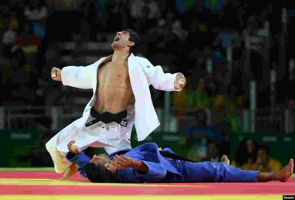 Lasha Shavdatuashvili of Georgia reacts after winning bronze by beating Sagi Muki of Israel in the men's 73- kilogram judo event.