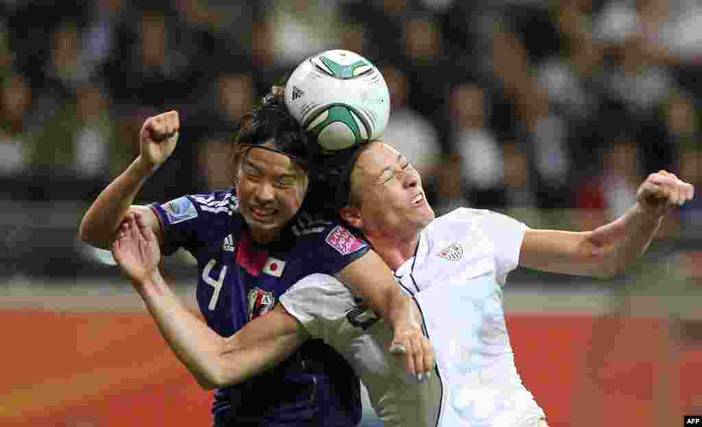 Japanese defender Saki Kumagai (left) and U.S. striker Abby Wambach compete for the ball in the final of the women's soccer World Cup in Germany on July 17. Japan won the tournament for the first time, in a penalty shoot-out after the match finished in a 2-2 draw following extra time.Photo by Daniel Roland for AFP