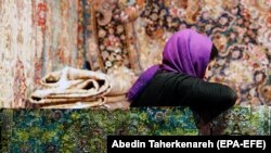 IRAN -- An Iranian woman visits the 28th handmade carpet exhibition at the international exhibition complex, in Tehran, August 26, 2019