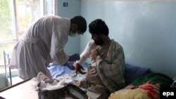An Afghan lecturer of Kandahar University receives medical treatment at a hospital after he was release by unknown gunmen, in Ghazni, June 10, 2014