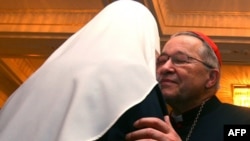 Russian Patriarch Aleksy II (left) gives his condolences to French Cardinal Andre Vingt-Trois in Moscow.