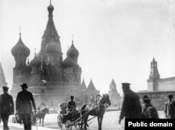 Horse-drawn carriages riding on Red Square.