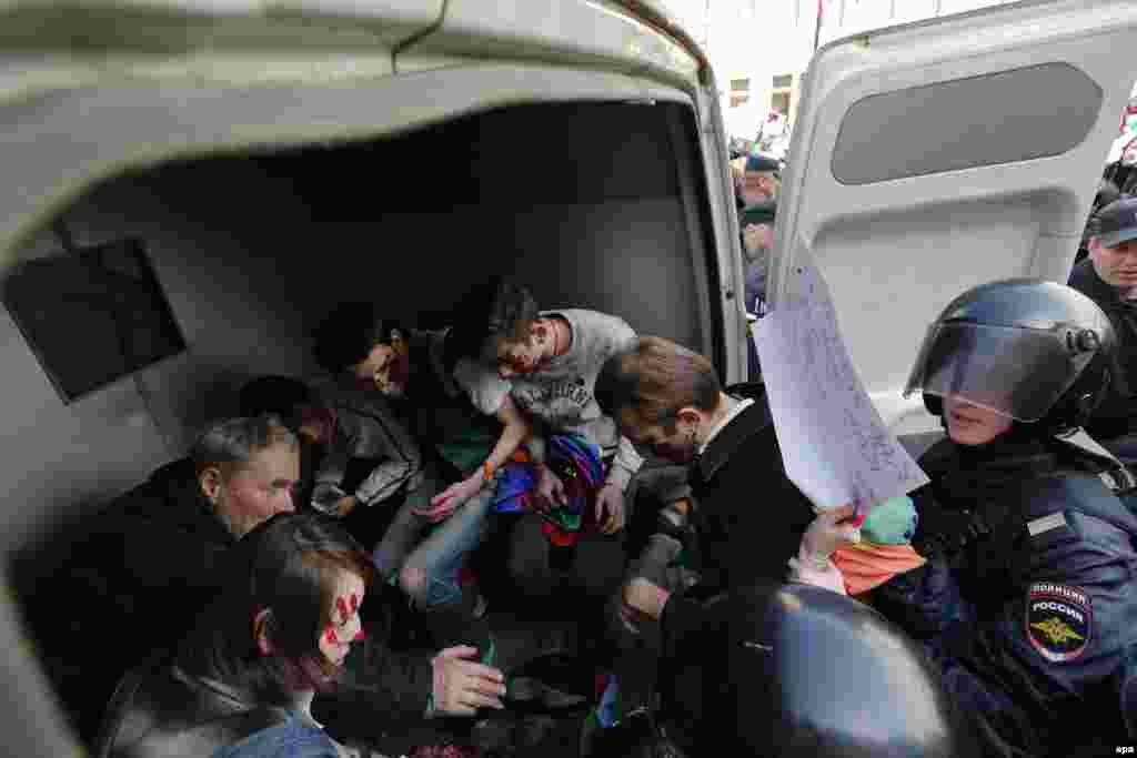 Police officers detain gay-rights activists during a May Day rally in St. Petersburg, Russia. (epa/Anatoly Maltsev)