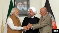 Iranian President Hassan Rouhani (C) with Indian Prime Minister Narendra Modi (L) and Afghan President Ashraf Ghani after signing a three-way transit agreement on Iran's southern port of Chabahar in May 2016.