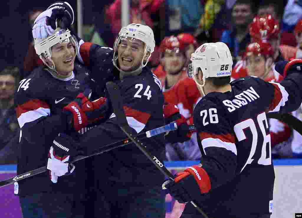 U.S. player T.J. Oshie (left) celebrates with teammates Ryan Callahan (center) and Paul Stastny (right) after scoring to win the game in a shootout against Russia during the Men&#39;s Preliminary Round Group A match.