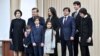 Shavkat Mirziyoev (second from left) poses for photographers with his family, including daughter Saida (center top), at a polling station after voting in Tashkent in December 2016.