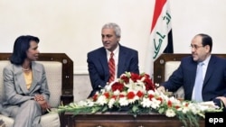 U.S. Secretary of State Condoleezza Rice (left) meets with Iraq's Prime Minister Nuri al-Maliki (right), aided by a translator, on a surprise visit to Baghdad.