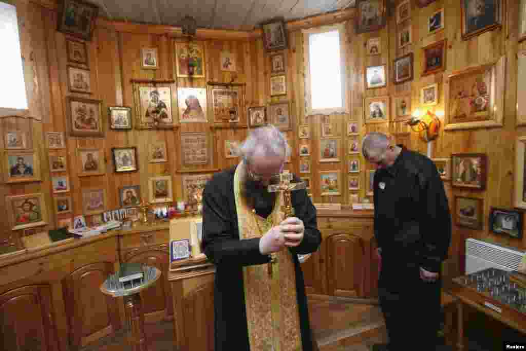 A priest leads the service for Orthodox Easter at the small church inside the prison complex.