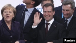 Almaniya kansleri Angela Merkel (solda) və Rusiyanın prezidenti Dmitry Medvedev (ortada) Şimal Axınının açılış mərasimində, 8 noyabr 2011