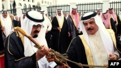 Bahrain's King Hamad bin Issa al-Khalifa (right) giving a sword to his Saudi counterpart, King Abdullah bin Abdul Aziz al-Saud, in Manama on April 18.