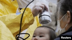 A baby is tested for radiation in Nihonmatsu, Fukushima Prefecture, on March 15.