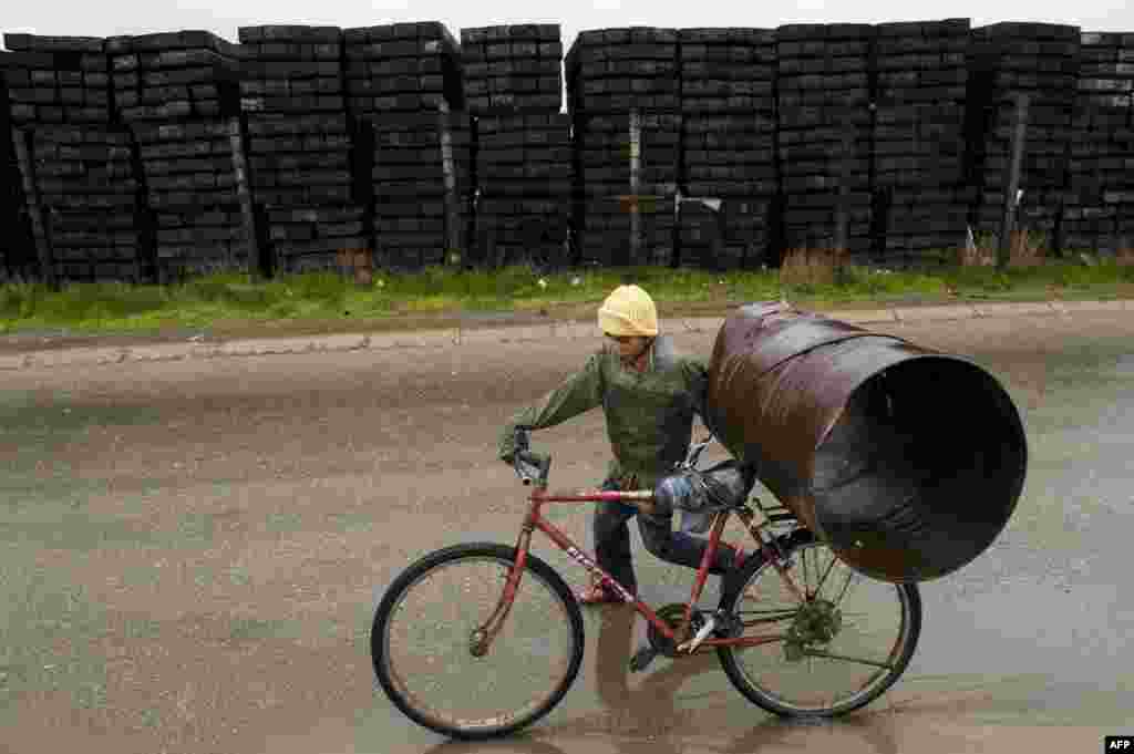 A Romany child loads recycled items on his bicycle in Pristina, Kosovo. April 8 was International Roma Day. (AFP/Armend Nimani)
