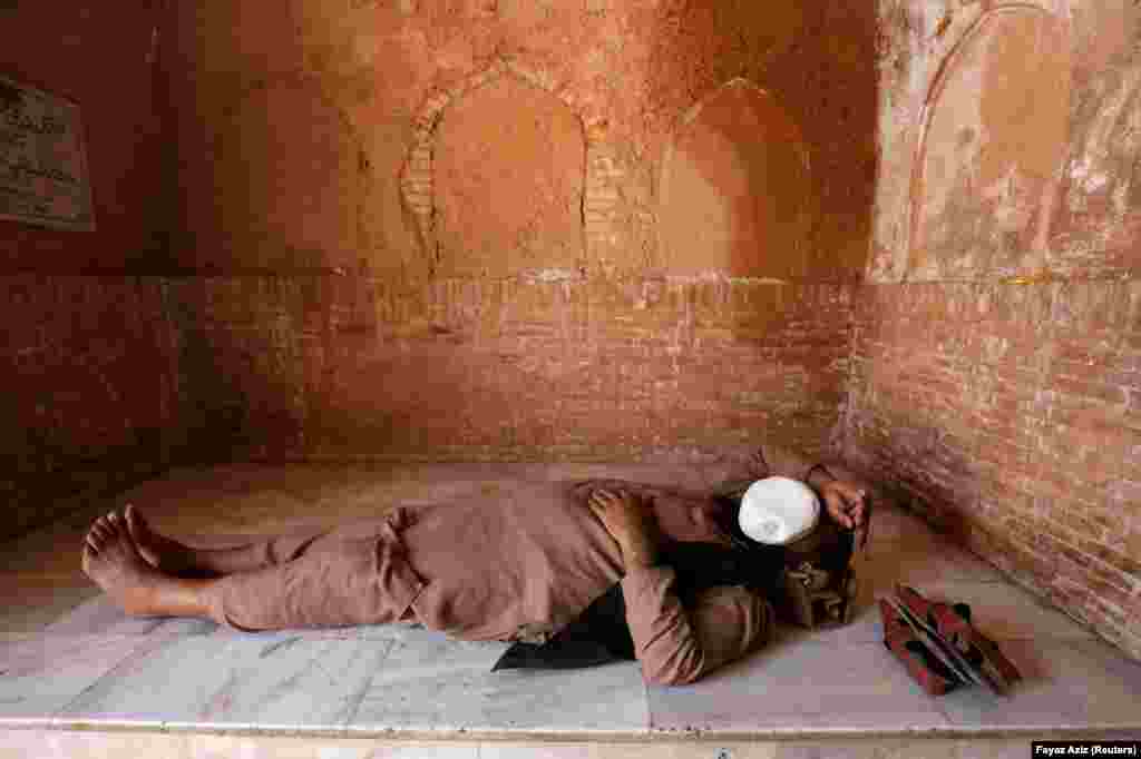 A man sleeps on a floor at the Mahabat Khan Mosque in Peshawar, Pakistan. (Reuters/Fayaz Aziz)