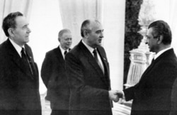 Karmal shakes hands with Soviet leader Mikhail Gorbachev (center) on a visit to Moscow in 1985.