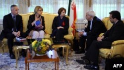 Helga Maria Schmid (second from left), deputy secretary general of the European External Action Service (EEAS), with EU foreign policy chief Catherine Ashton (center) during talks with Iranian Foreign Minister Mohammed Javad Zarif (second from right) and Seyyed Abbas Araghchi (right) in Geneva on November 20 over Iran's nuclear program.
