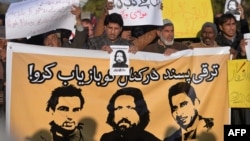 FILE: Pakistani human rights activists hold images of bloggers who have gone missing during a protest in Islamabad in January.