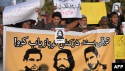 Pakistani human rights activists hold images of some of the bloggers who have gone missing during a protest in Islamabad on January 10.