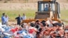 A worker uses a bulldozer to crush crates of banned peaches outside the city of Novozybkov, about 600 kilometers from Moscow, on August 7.