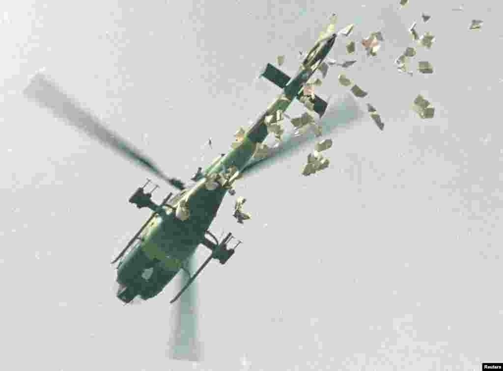 A military helicopter drops leaflets ordering protesters to leave Tiananmen Square immediately on May 22.