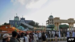 Worshipers lineup for a security scan before entering a Sufi shrine in Karachi.