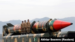 FILE: Pakistani soldiers stand beside a Shaheen III surface-to-surface ballistic missile during the Pakistan Day military parade in Islamabad on March 23.