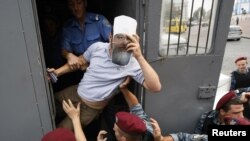 Policemen detaining a member of the Ukrainian nationalist party Svoboda (Freedom) as he intends to take part in a rally to protest against the visit of Russian Patriarch Kirill in Kyiv on July 26.