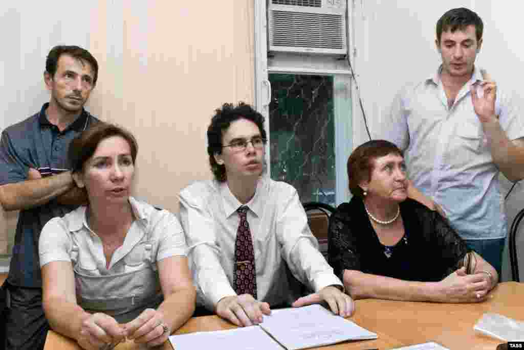 Natalya Estemirova (seated left) with journalists and staff members of the Grozny branch of the Memorial human rights group on July 26, 2007