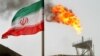 IRAN -- FILE PHOTO: A gas flare on an oil production platform in the Soroush oil fields is seen alongside an Iranian flag in the Persian Gulf, Iran, July 25, 2005.