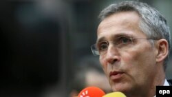 NATO Secretary-General Jens Stoltenberg talks to the media as he arrives for the European council of defense ministers in Brussels on November 15.