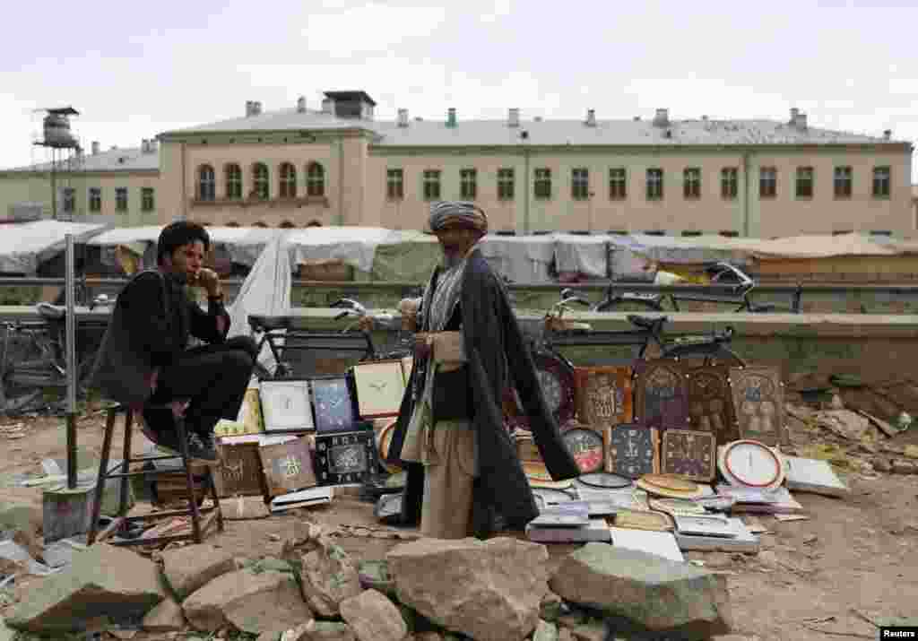 An Afghan man buys a wall clock in Kabul. (Reuters/Mohammad Ismail)