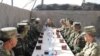 Azerbaijani President Ilham Aliyev (center) talks to soldiers serving in the Agdam district east of Nagorno-Karabakh on August 6.