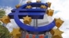 A giant logo of the euro currency stands in front of the European Central Bank in the banking district of Frankfurt, Germany.
