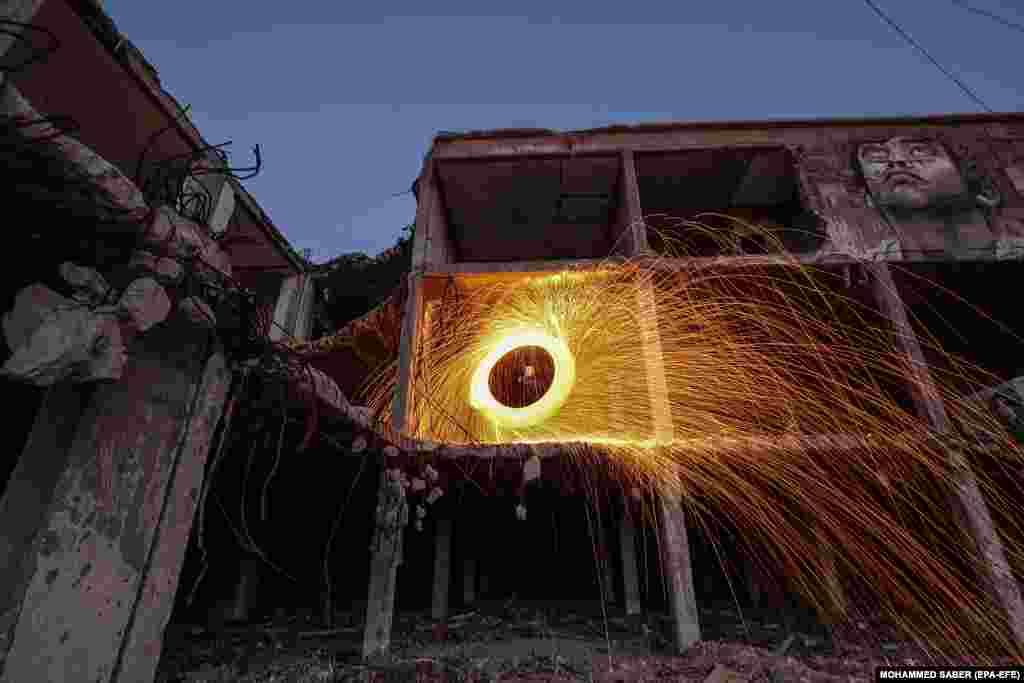 A Palestinian lights fireworks celebrating the holy month of Ramadan in Gaza City. (epa-EFE/Mohammed Saber)