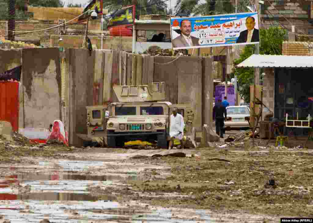 A military vehicle stands at a checkpoint in southern Baghdad after a heavy rain.