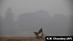 Një çiklist në Lahoren e mbështjellë prej smogut.