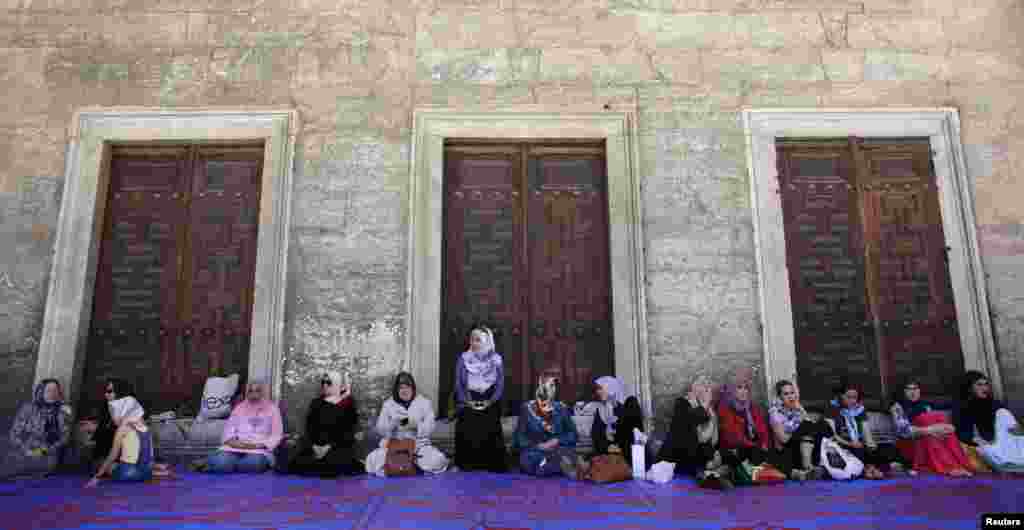 Women wait for Friday Prayers in the courtyard of Sultanahmet Mosque, known as the Blue Mosque, in Istanbul. (Reuters/Murad Sezer)