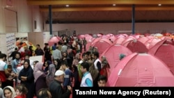 People are seen sheltering at a stadium in Red Crescent tents after a flooding in Golestan province, Iran, March 24, 2019.