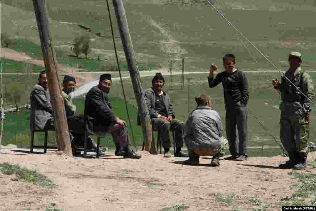 Men relax outside in the village. The Turkish government sends mullahs to teach the Kyrgyz the tenets of Islam, but they otherwise have little contact with their neighbors in the region, who are ethnic Kurds.